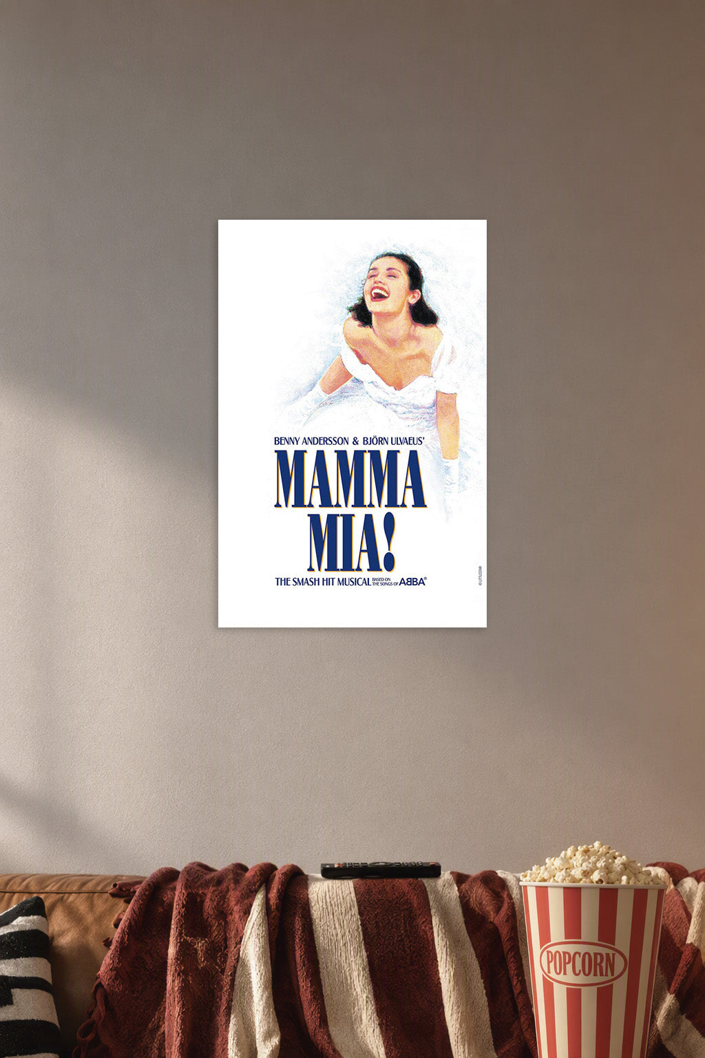 Mamma Mia! Musical in a cozy movie room above a brown sofa with popcorn.