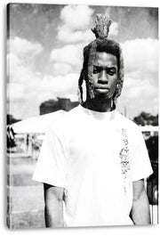 Canvas wall art print featuring a monochrome portrait of a man with raised dreadlocks and a white shirt outdoors.