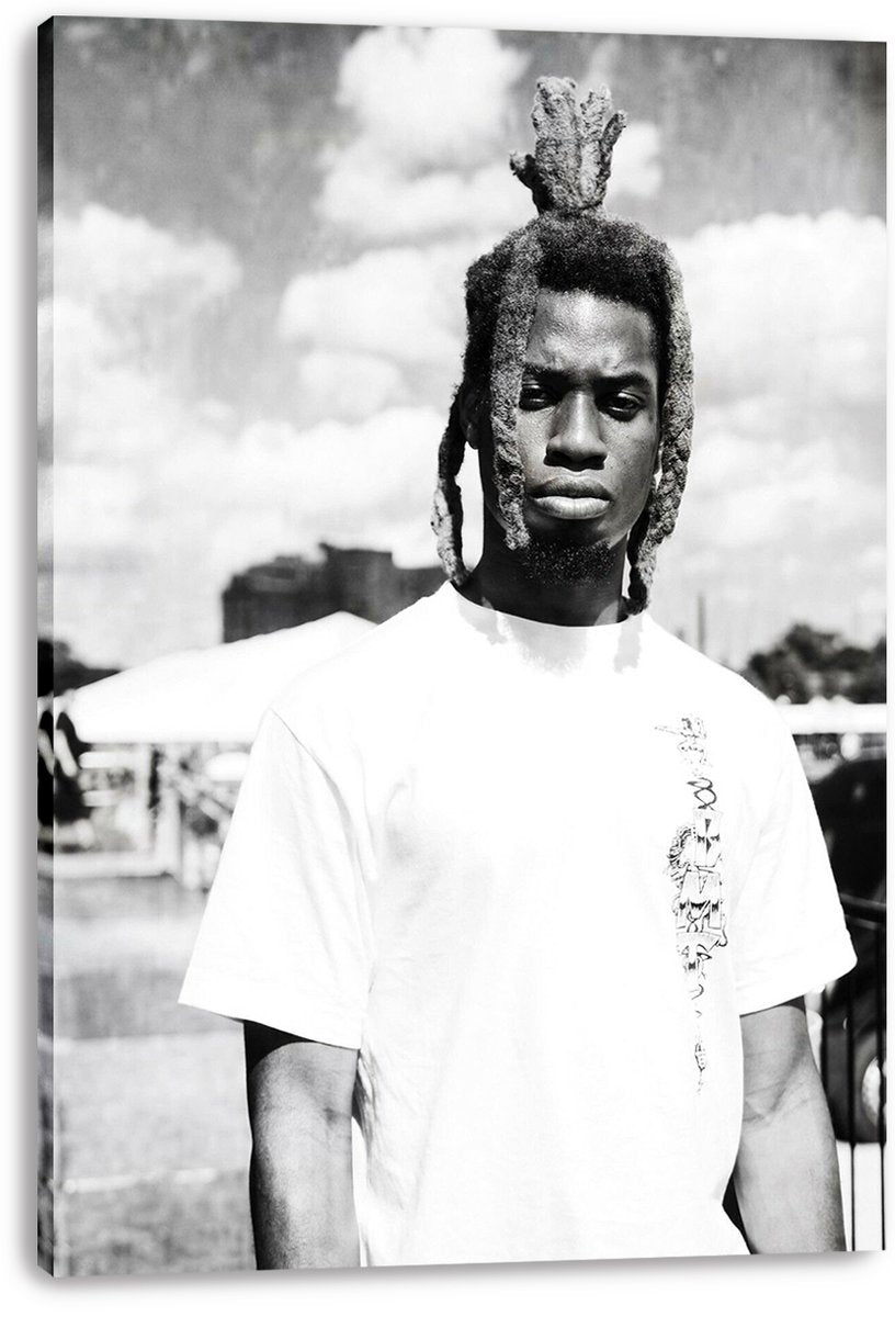 Canvas wall art print featuring a monochrome portrait of a man with raised dreadlocks and a white shirt outdoors.
