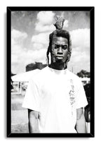 Framed wall art print with a black border, portraying a man with dreadlocks in a white T-shirt beneath clouds.