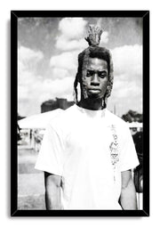 Framed wall art print with a black border, portraying a man with dreadlocks in a white T-shirt beneath clouds.
