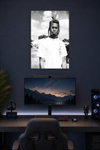 Man with Dreadlocks in a gaming desk setup above a monitor.