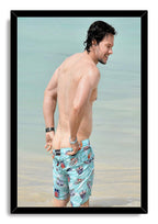 Mark Wahlberg framed wall art print depicts the actor smiling at the shore, set in a black rectangular frame.
