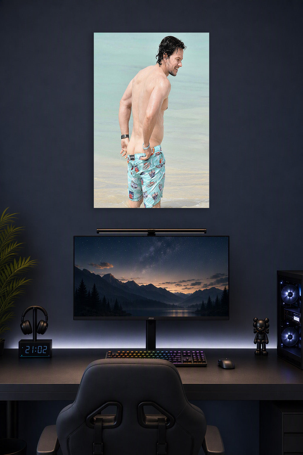 Mark Wahlberg in a gaming desk setup above a monitor.