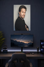 Mark Wahlberg in a gaming desk setup above a monitor.