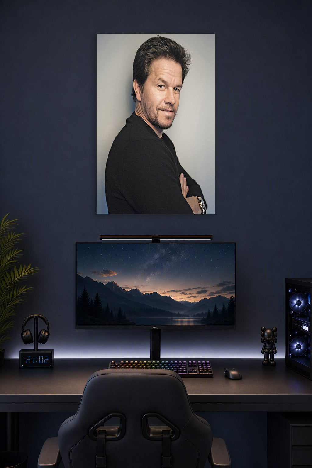 Mark Wahlberg in a gaming desk setup above a monitor.