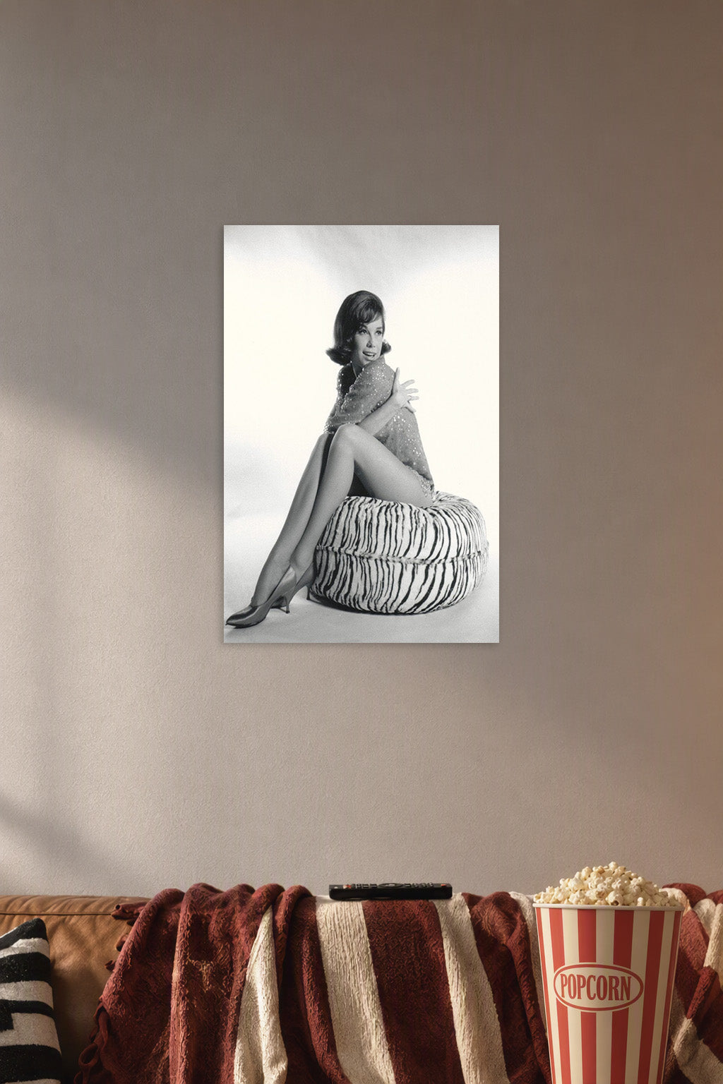 Mary Tyler Moore in a cozy movie room above a brown sofa with popcorn.