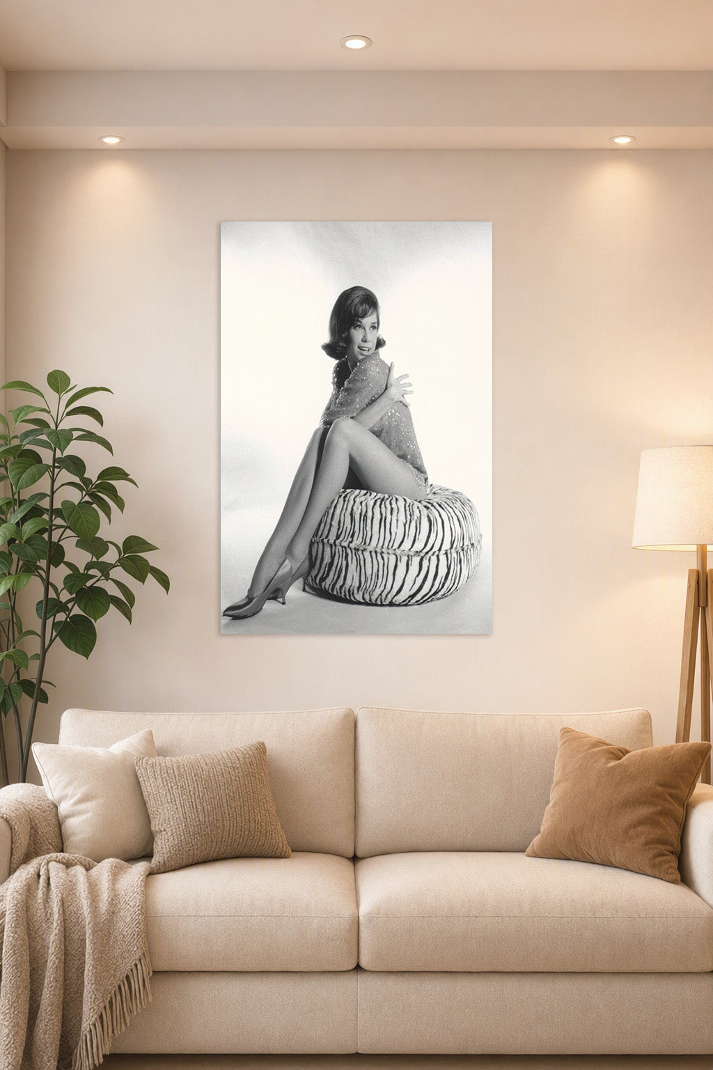 Mary Tyler Moore in a bright living room above a beige sofa.