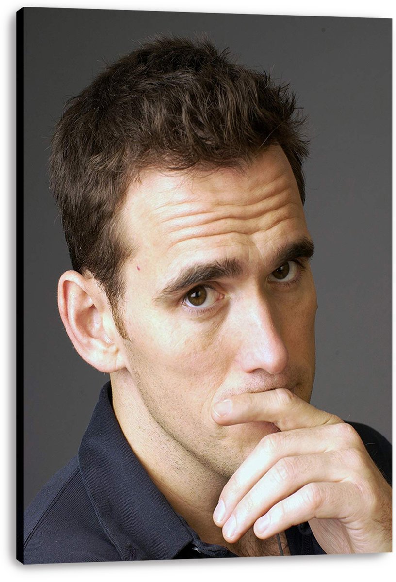 Matt Dillon canvas wall art print featuring a close-up portrait, thoughtful gaze, dark shirt, and deep gray backdrop.
