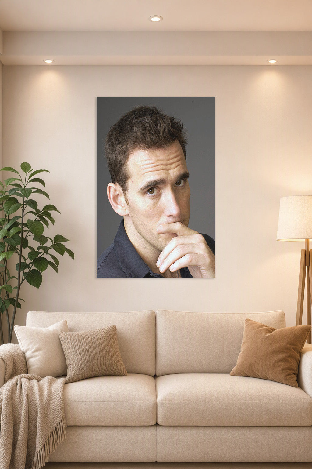 Matt Dillon in a bright living room above a beige sofa.