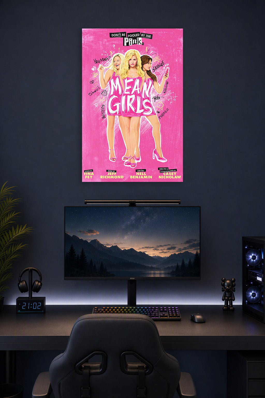 Mean Girls Musical in a gaming desk setup above a monitor.