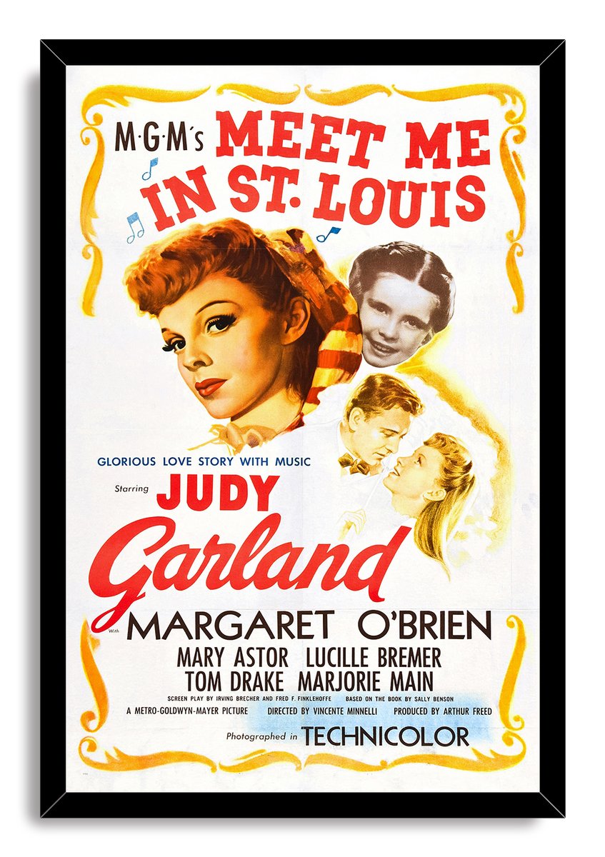 Meet Me in St. Louis framed wall art print with Judy Garland portraits, musical notes, red typography, and a black frame.