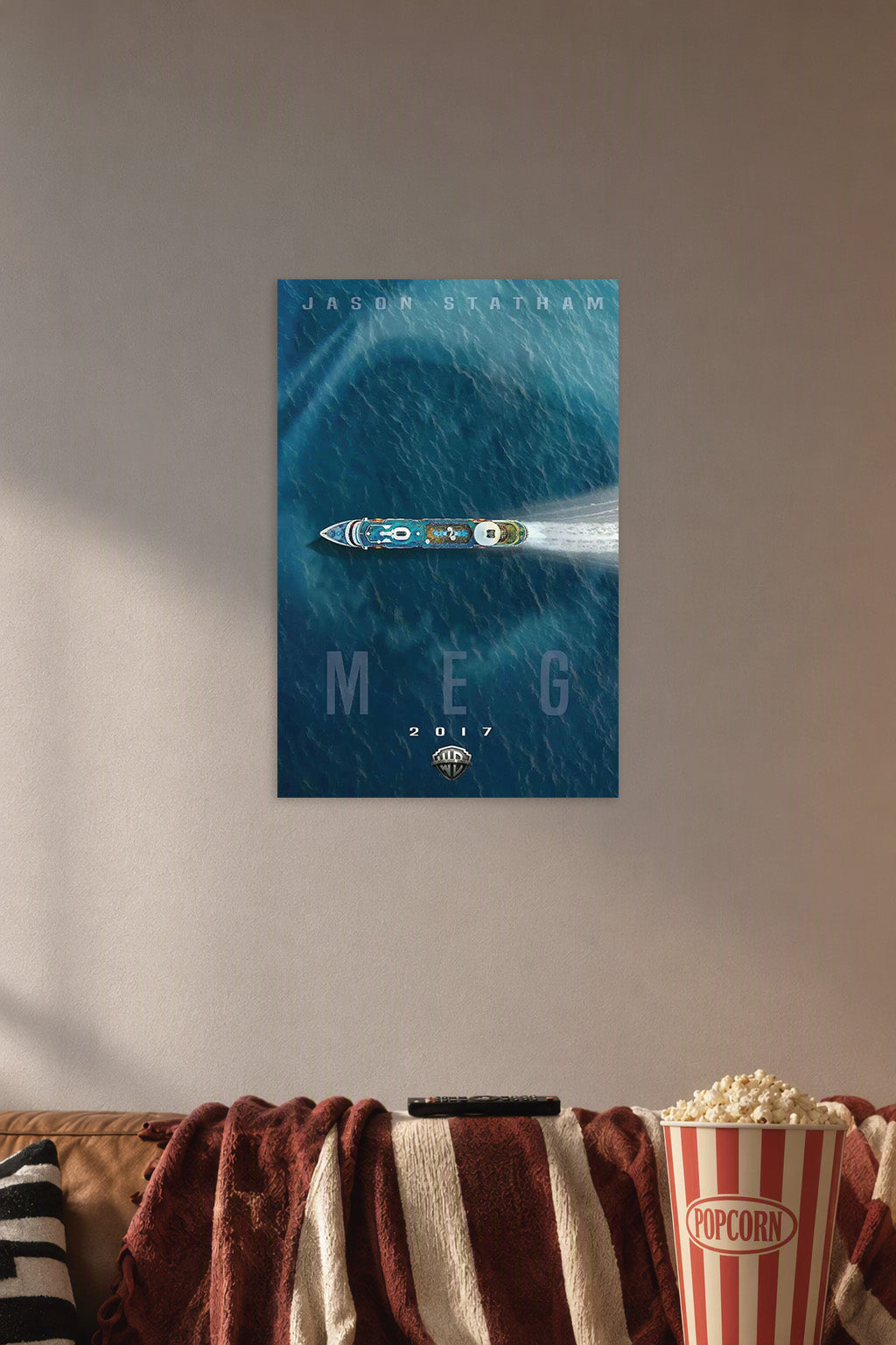 Meg Movie Jason Statham in a cozy movie room above a brown sofa with popcorn.