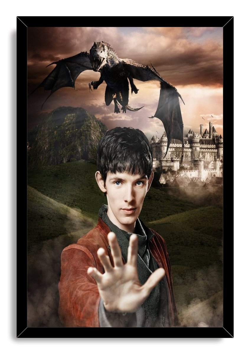 Merlin framed wall art print features a young sorcerer reaching forward beneath a dragon over misty hills and a castle.
