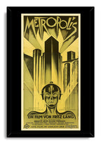 Metropolis movie poster framed wall art print in a black frame, with a robot portrait, angular towers, and German film text.