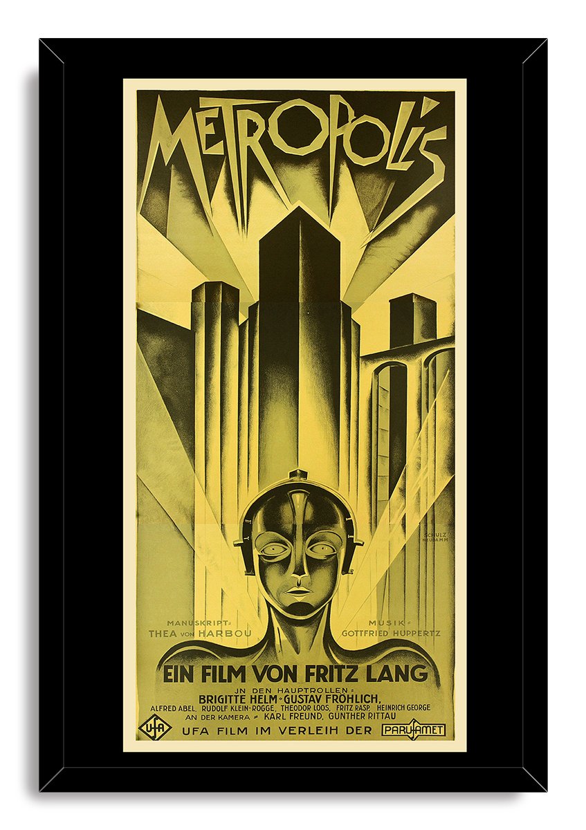 Metropolis movie poster framed wall art print in a black frame, with a robot portrait, angular towers, and German film text.