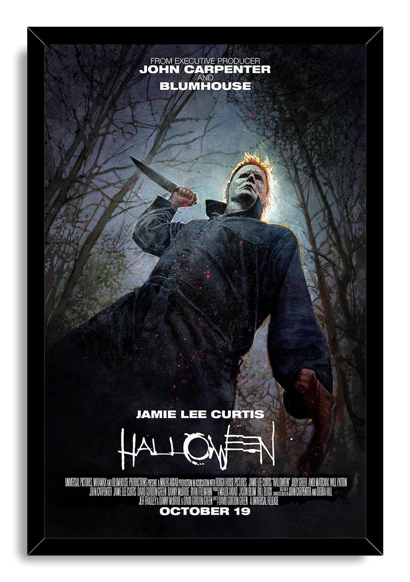 Michael Myers Halloween framed wall art print portrays the masked killer holding a knife in a moonlit forest within a black frame.