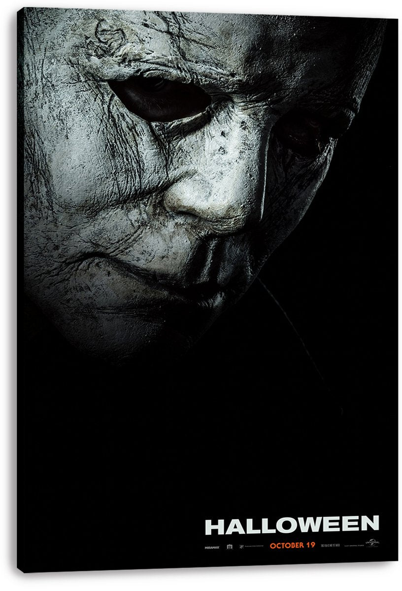 Michael Myers Halloween canvas wall art print displaying a close-up cracked gray mask, dark eye sockets, and orange October 19 text.