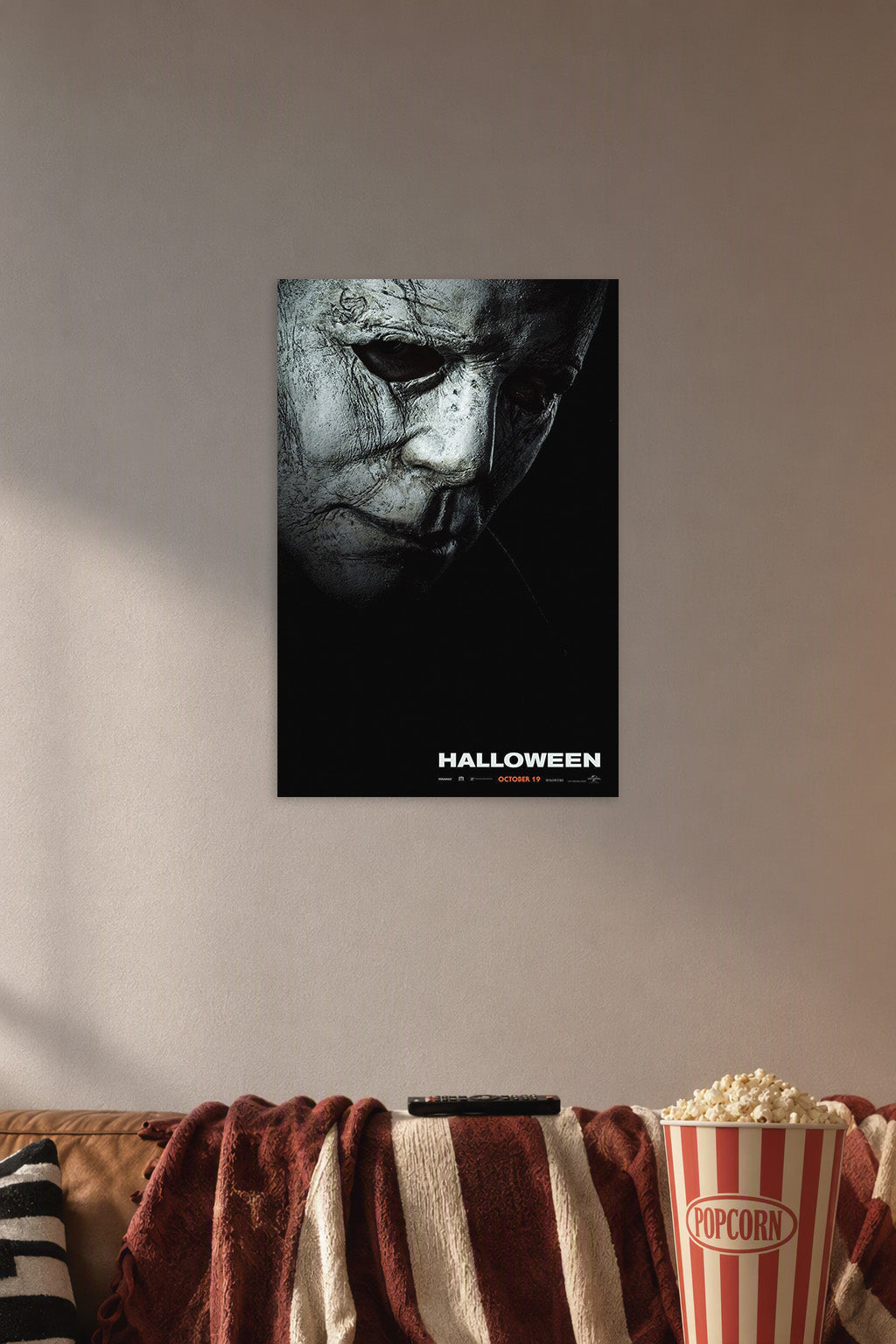 Michael Myers Halloween Movie Poster in a cozy movie room above a brown sofa with popcorn.