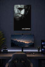Michael Myers Halloween Movie Poster in a gaming desk setup above a monitor.