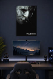 Michael Myers Halloween Movie Poster in a gaming desk setup above a monitor.