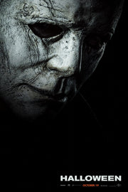 Michael Myers Halloween movie poster wall art print with a weathered pale mask emerging from black shadows above the title.