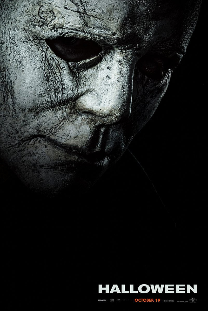 Michael Myers Halloween movie poster wall art print with a weathered pale mask emerging from black shadows above the title.