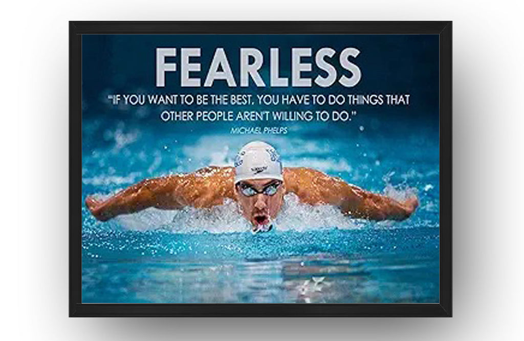 Michael Phelps motivational wall art print in a black frame depicts a swimmer performing butterfly under bold white “FEARLESS” text.