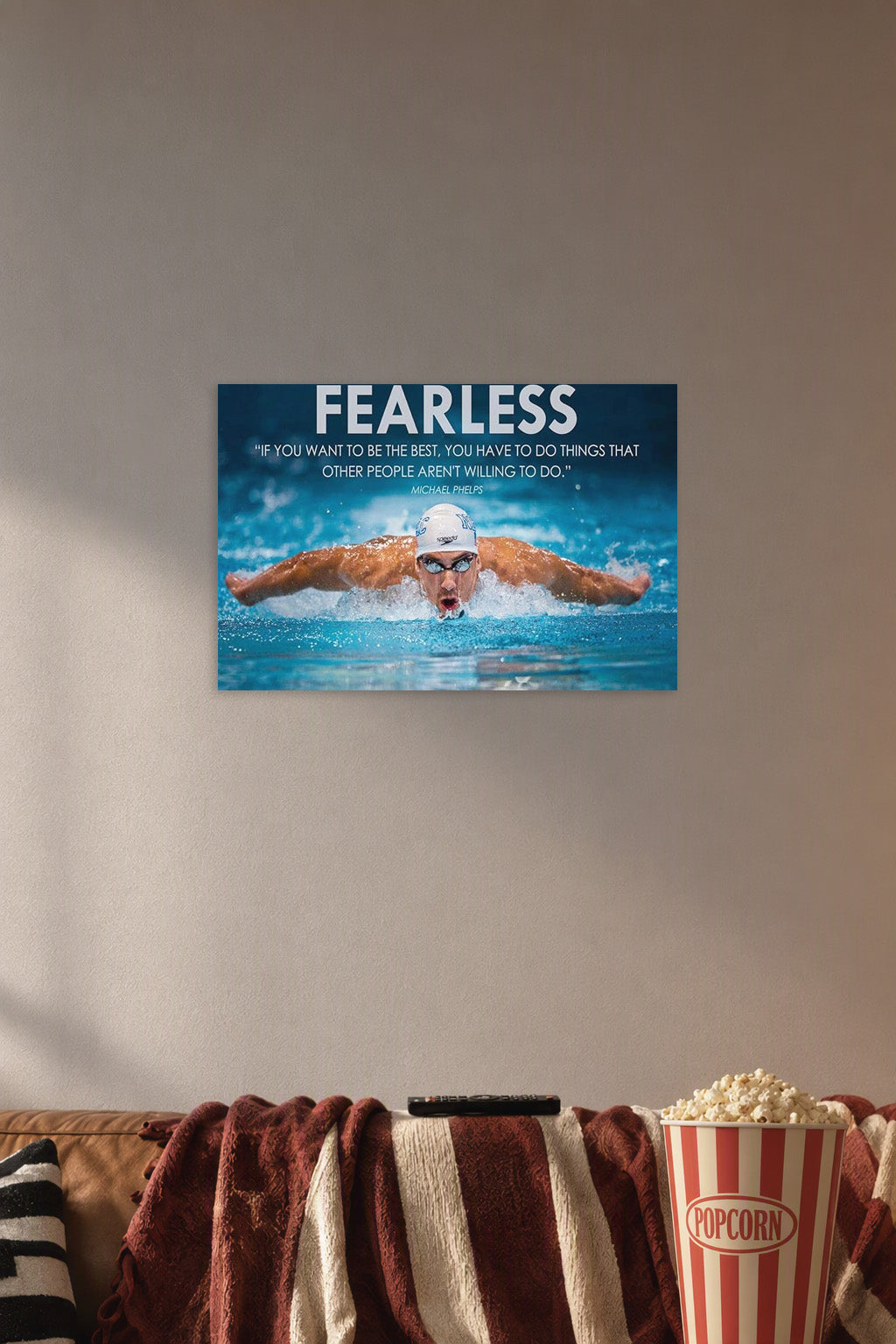 Michael Phelps Motivational Quotes HD Poster in a cozy movie room above a brown sofa with popcorn.