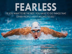 Michael Phelps motivational poster features a swimmer in a white cap doing butterfly through bright blue water beneath the word “FEARLESS.