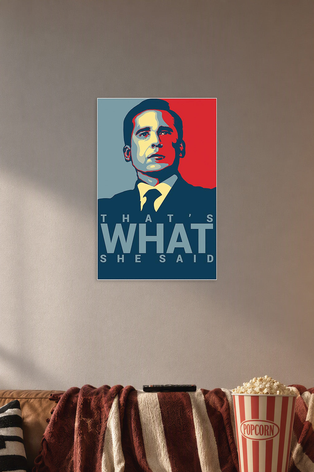 Michael Scott's Funny Motivational Poster."That's What" Print in a cozy movie room above a brown sofa with popcorn.