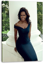Michelle Obama canvas wall art print features her seated by a white column in a navy off-the-shoulder dress, with greenery behind.