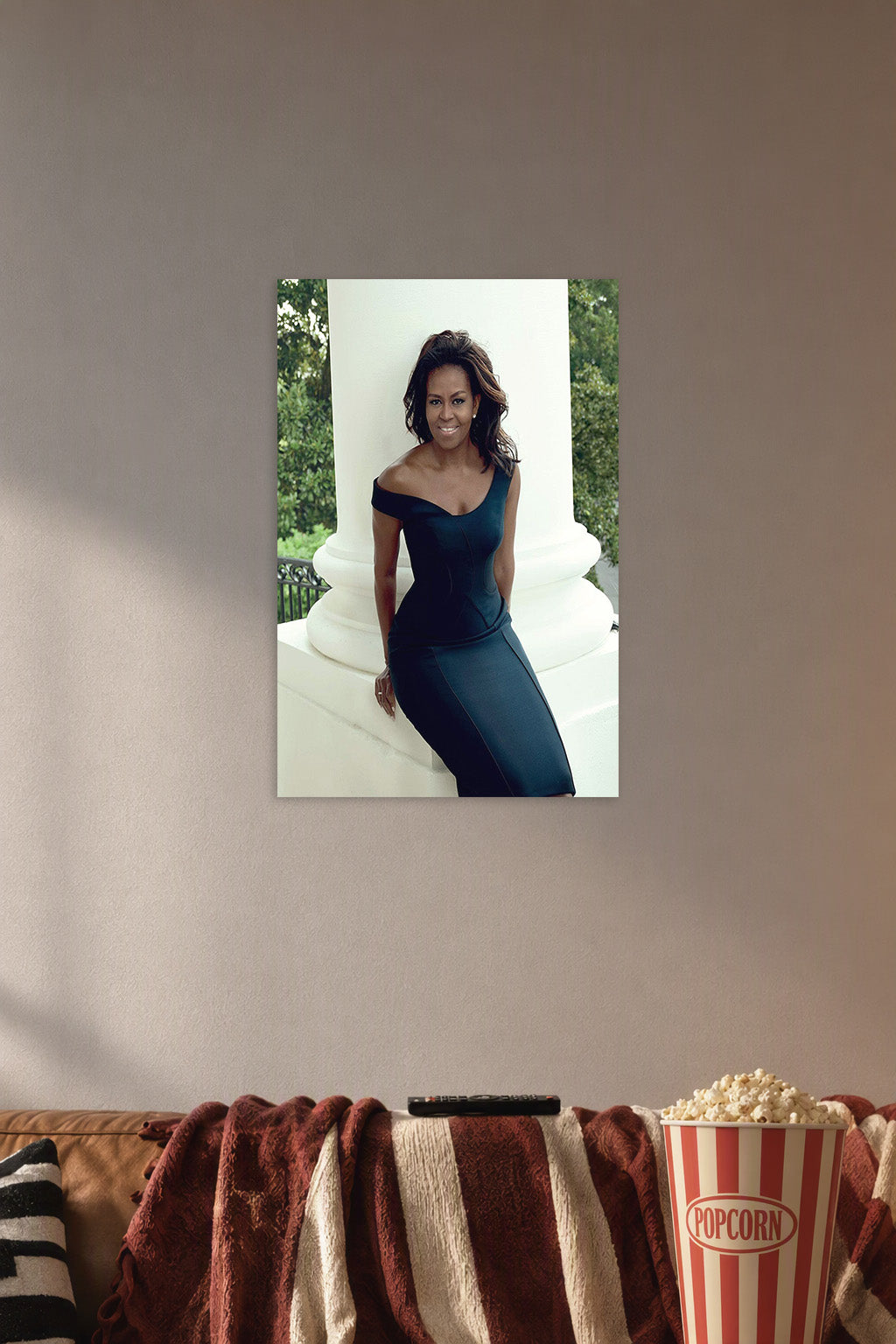 Michelle Obama in a cozy movie room above a brown sofa with popcorn.