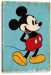 Mickey Mouse canvas wall art print with visible wrapped edges, red shorts and yellow shoes against a weathered turquoise backdrop.