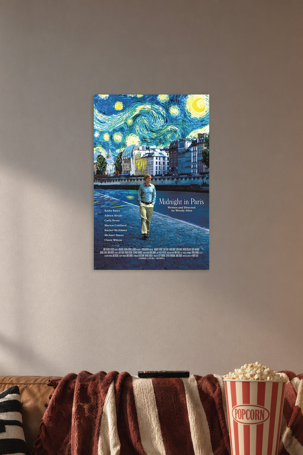 Midnight in Paris Movie Poster in a cozy movie room above a brown sofa with popcorn.