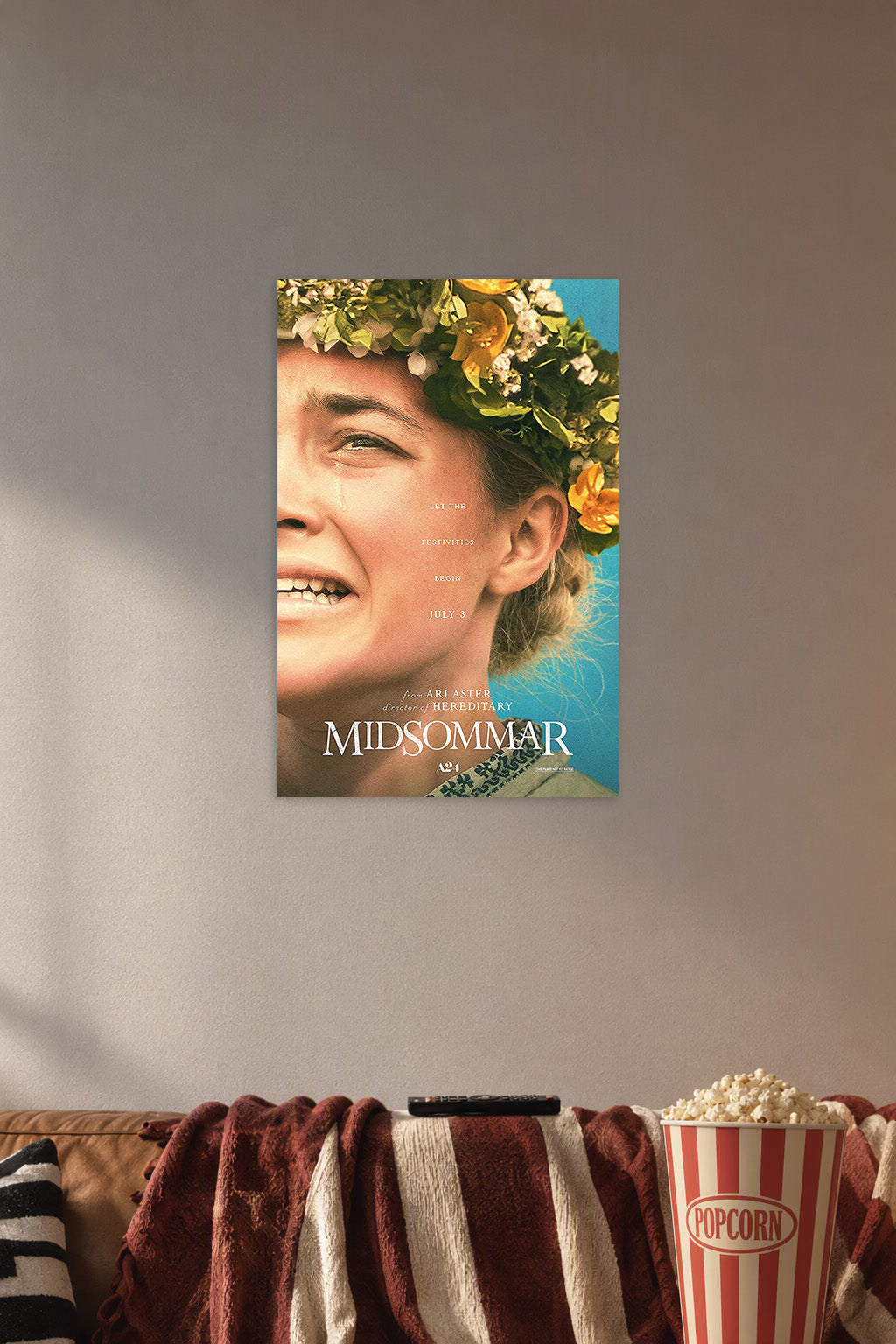 Midsommar Movie Poster in a cozy movie room above a brown sofa with popcorn.