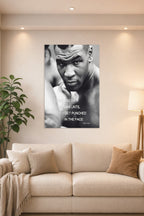 Mike Tyson in a bright living room above a beige sofa.