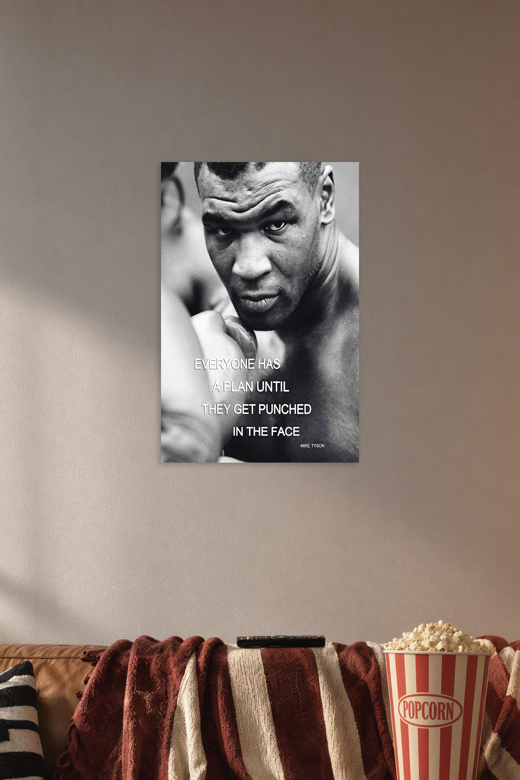 Mike Tyson in a cozy movie room above a brown sofa with popcorn.