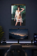 Milla Jovovich in a gaming desk setup above a monitor.