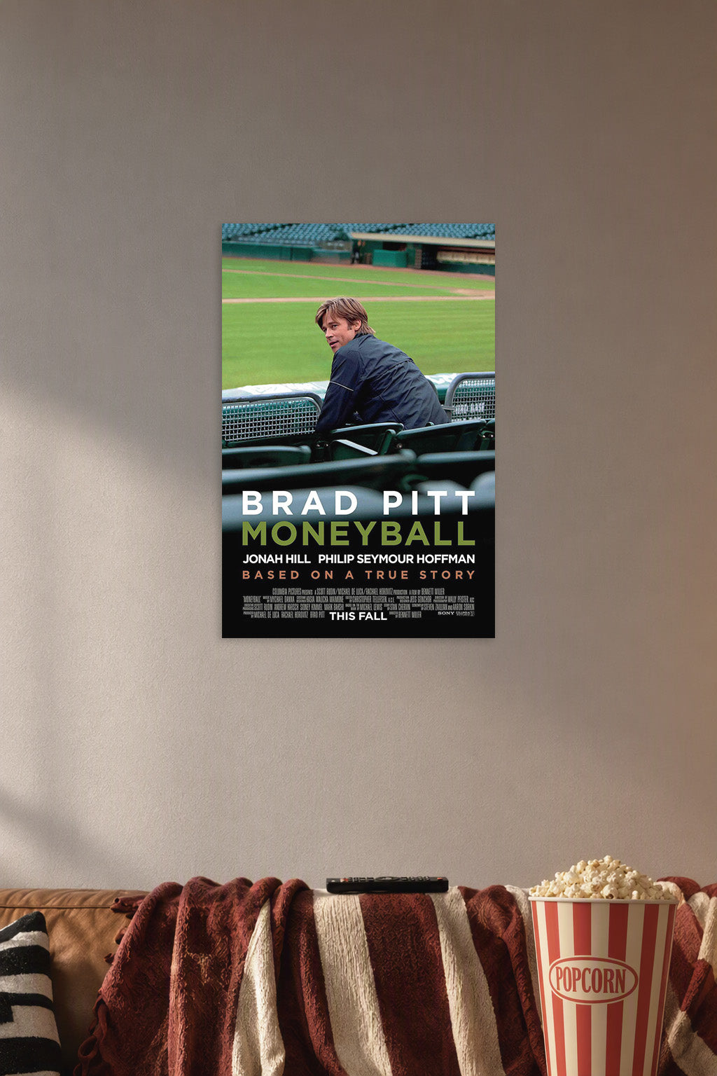 Moneyball Movie featuring Brad Pitt in a cozy movie room above a brown sofa with popcorn.