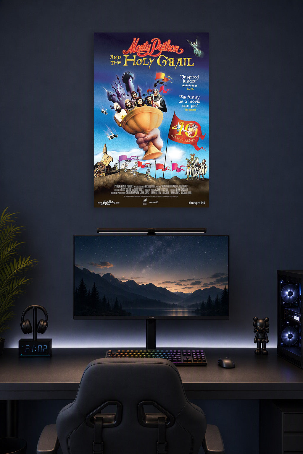 Monty Python and the Holy Grail Movie Poster in a gaming desk setup above a monitor.
