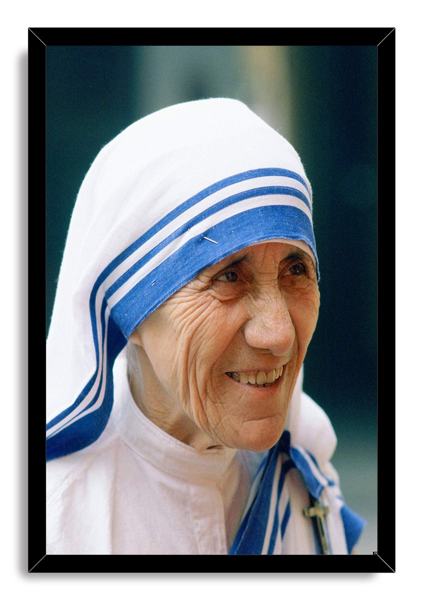 Mother Teresa framed wall art print featuring a close-up smiling portrait in a white and blue striped headscarf within a black frame.