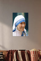 Mother Teresa in a cozy movie room above a brown sofa with popcorn.