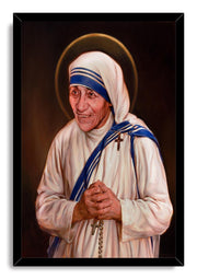 Mother Teresa framed wall art print depicts a warm portrait with clasped hands, rosary beads, blue-trimmed habit, and halo.
