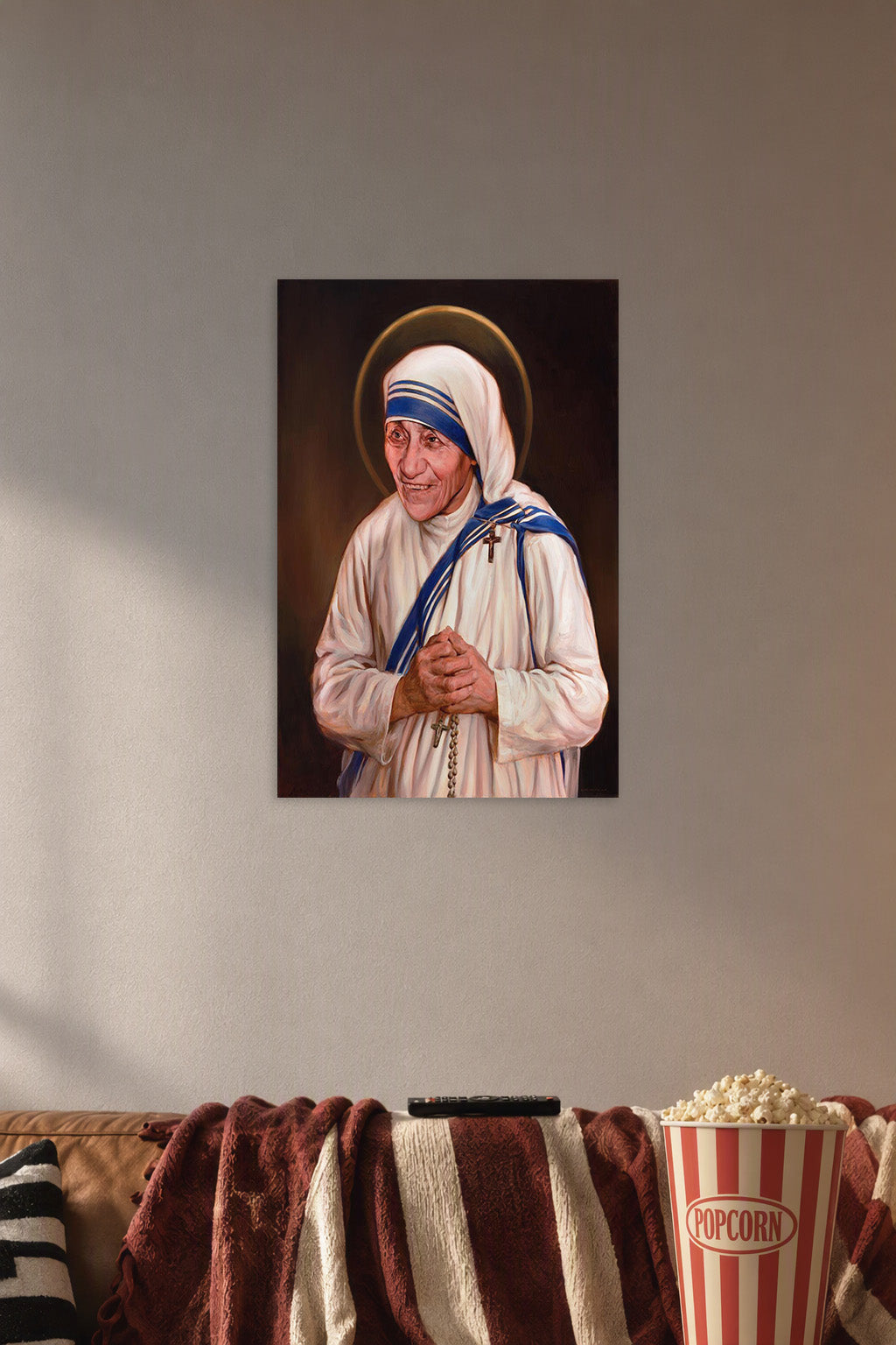 Mother Teresa Saint in a cozy movie room above a brown sofa with popcorn.
