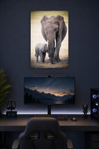 Mother and Baby Elephant in a gaming desk setup above a monitor.