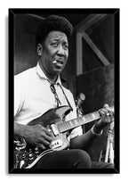 Muddy Waters framed wall art print with a black-and-white portrait of the guitarist playing onstage with a cigarette.