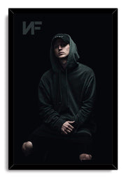 NF framed wall art print depicts the rapper seated in a dark hoodie and cap, with a subtle NF logo at the upper left.