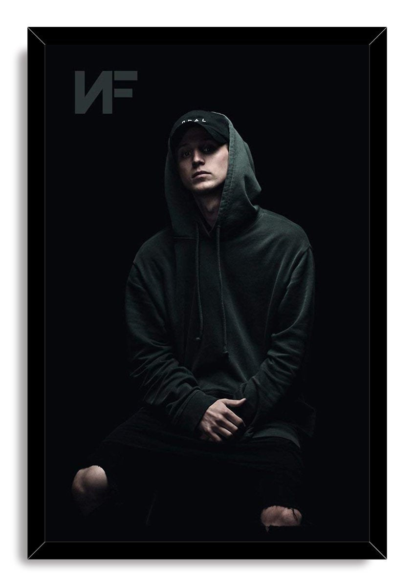 NF framed wall art print depicts the rapper seated in a dark hoodie and cap, with a subtle NF logo at the upper left.
