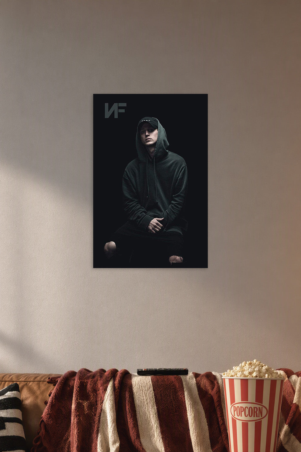NF Rapper in a cozy movie room above a brown sofa with popcorn.